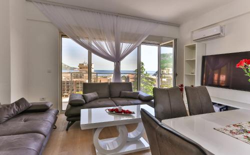 - un salon avec un canapé et une table dans l'établissement Luxury Korda apartments 011, à Budva