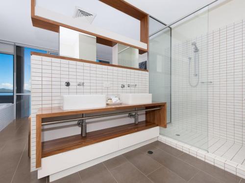 a bathroom with two sinks and a shower at 1 Bright Point Apartment 4501 in Nelly Bay