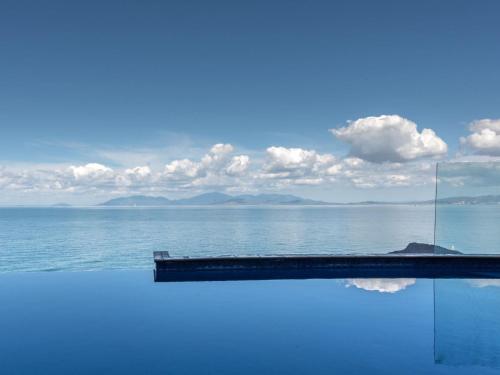 a swimming pool with a view of the ocean at 1 Bright Point Apartment 4501 in Nelly Bay
