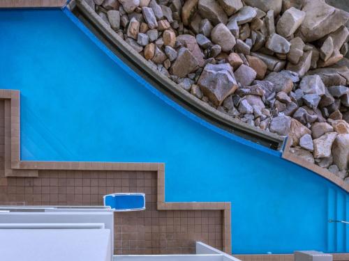 a pile of rocks on top of a blue wall at 1 Bright Point Apartment 4501 in Nelly Bay