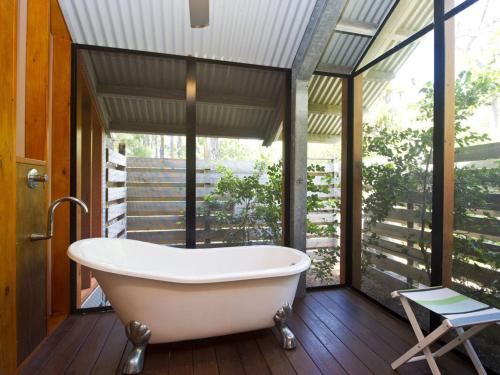 a bath tub in a bathroom with a window at The Pines in Horseshoe Bay