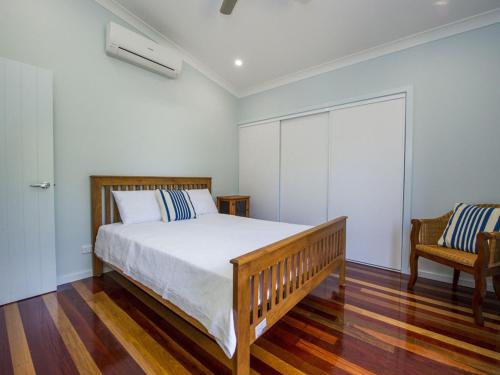 a bedroom with a bed and a chair at Debs Shed in Arcadia