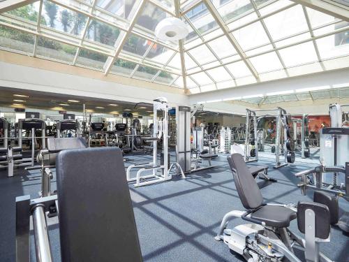 a gym with lots of cardio equipment in a building at Pullman Sao Paulo Ibirapuera in Sao Paulo