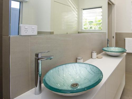 Picnic Bay的住宿－Reflections Turquoise Villa 4，一个带蓝色碗水槽的柜台浴室