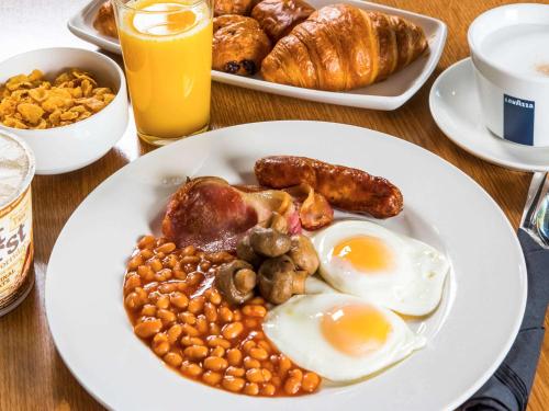 a plate of breakfast food with eggs and beans at ibis Styles Crewe in Crewe