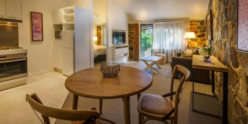 a kitchen with a table, chairs and a refrigerator at Bright Mystic Valley in Bright