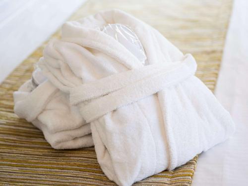 a pile of white towels sitting on a table at Mercure Oostende in Ostend