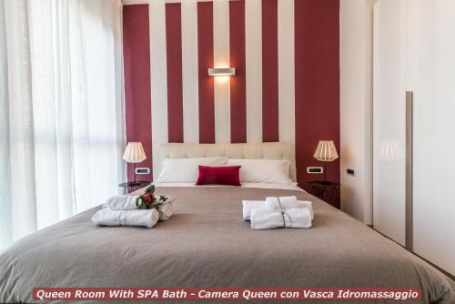 a bedroom with a large bed with two towels at 4 Star Bologna Train Station - Self Check-In in Bologna