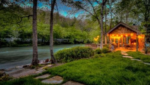 a cabin in the woods next to a river at Hooked On Toccoa in Blue Ridge