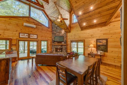 a dining room with a table and a fireplace at Hooked On Toccoa in Blue Ridge