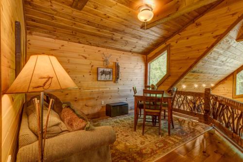 a living room with a couch and a table in a cabin at Hooked On Toccoa in Blue Ridge