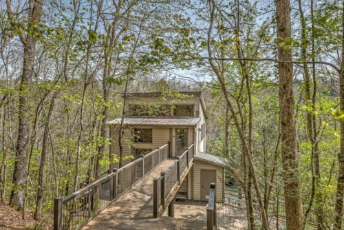 a house in the woods with a staircase leading up to it at Falcons Nest in McCaysville
