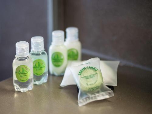a counter with bottles of detergent and a bag of soap at Novotel São Paulo Berrini in Sao Paulo
