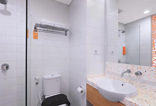 a bathroom with a toilet and a sink at Starlet Hotel BSD City in Tangerang