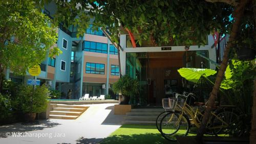 a bike parked in front of a building at Phuket Airport Place in Nai Yang Beach