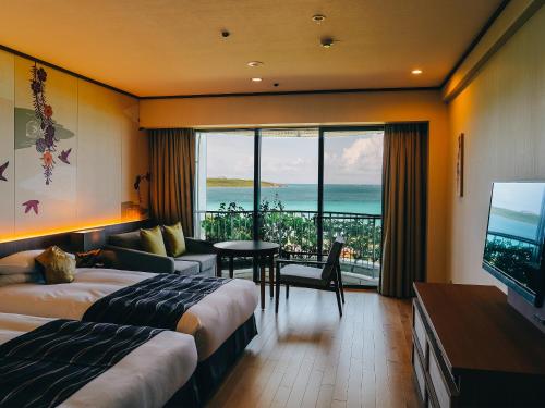 a hotel room with two beds and a view of the ocean at Miyakojima Tokyu Hotel & Resorts in Miyako-jima