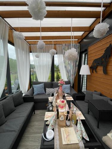 a living room with a couch and a table at Osada Kotarz in Brenna