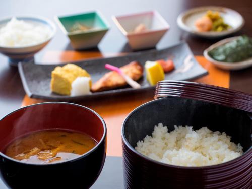 a table with a bowl of soup and a plate of food at Miyakojima Tokyu Hotel & Resorts in Miyako Island