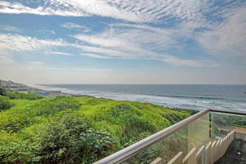 a view of the ocean from the balcony of a house at Sea De La Vie 25 by Host Agents in La Mercy