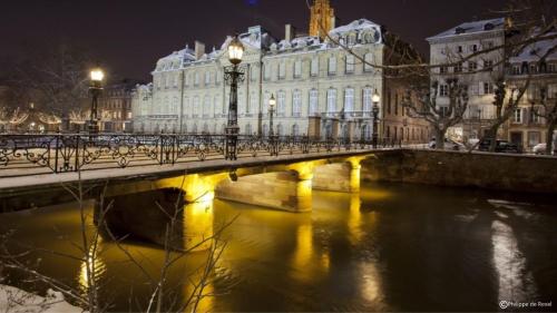 a bridge over a river in front of a building at Hotel Suisse in Strasbourg