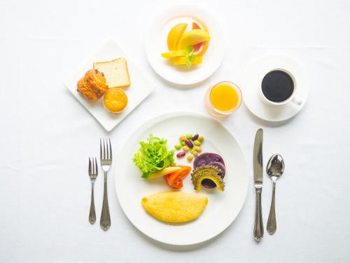 a table with a plate of food and a cup of coffee at Miyakojima Tokyu Hotel & Resorts in Miyako Island