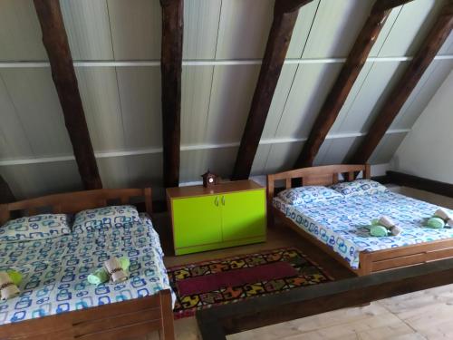 a bedroom with two beds and a green cabinet at Suri in Plužine