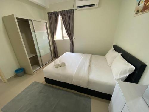 a hotel room with a bed and a window at Tiara Desaru Seaview Residence in Desaru