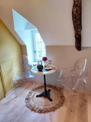 a table and two chairs in a room at Studio Exupere in Bayeux