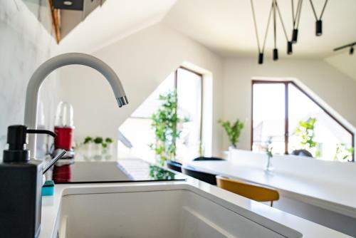 a kitchen with a sink and some windows at Sunny Sight Zlatibor in Zlatibor