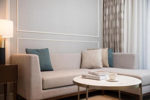 a living room with a couch and a coffee table at Lotte Hotel Jeju in Seogwipo