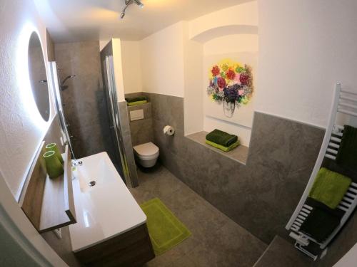 bagno con doccia, lavandino e servizi igienici di Melanie's Appartement a Westendorf