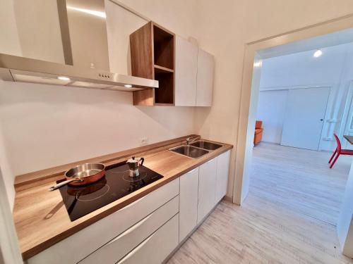 a kitchen with a sink and a stove top oven at BRIBANO HOSTEL & bike sharing-workers and tourists hospitality in Sedico