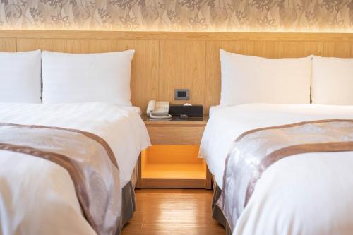 Una cama o camas en una habitación de HE TI Hotel