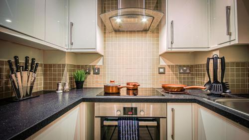 a kitchen with white cabinets and a stove top oven at Superb City Center 1 or 2 BR Apts King Bed in Southampton