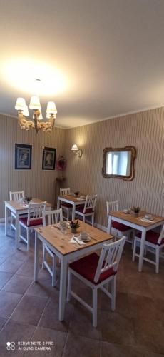 a dining room with wooden tables and white chairs at B&B Il Cardinale in Rocca di Mezzo