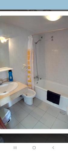 La salle de bains est pourvue d'une baignoire, de toilettes et d'un lavabo. dans l'établissement Un dormitorio frente playa El Medano, à El Médano