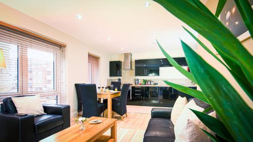 a living room with a table and chairs and a kitchen at Superb City Center 1 or 2 BR Apts King Bed in Southampton