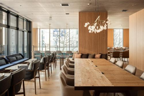 a conference room with a long wooden table and chairs at Bespoke Hotel Sapporo in Sapporo