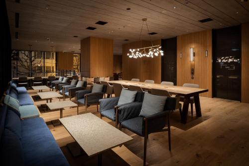 a dining room with a long table and chairs at Bespoke Hotel Sapporo in Sapporo