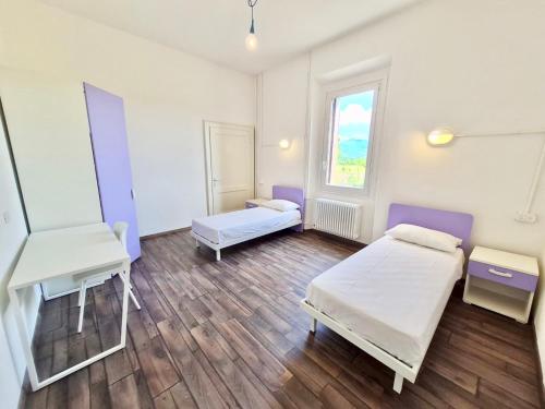 a hospital room with two beds and a desk at BRIBANO HOSTEL & bike sharing-workers and tourists hospitality in Sedico