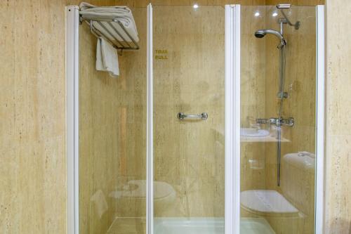 a shower with a glass door in a bathroom at Amura Alcobendas in Alcobendas