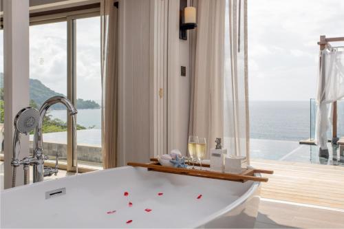 a bath tub in a bathroom with a view of the ocean at The Shore At Katathani - Adult Only - SHA Extra Plus in Kata Beach
