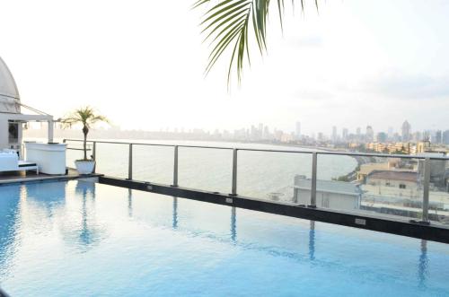 a swimming pool on top of a building with a view of the city at InterContinental Marine Drive Mumbai, an IHG Hotel in Mumbai