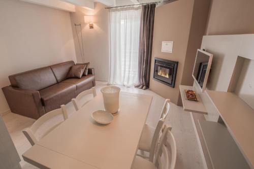 a living room with a table and a couch at BILOCALE BELLA VISTA in Temù