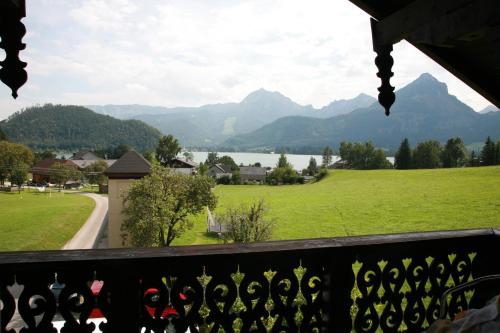 a view from a balcony with a view of a lake and mountains at Haus Daheim in St. Wolfgang