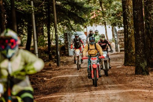 a group of people riding motorcycles on a dirt road at Vallicciola Nature Hotel in Tempio Pausania
