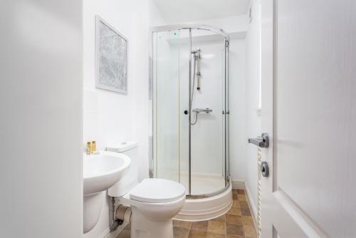 a bathroom with a shower and a toilet and a sink at Elliot Suite No3 - Donnini Apartments in Ayr