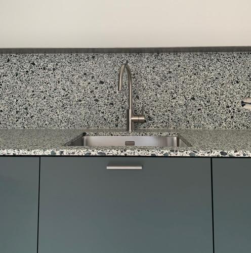 a kitchen with a sink and a counter top at Huyze Cordoeanier in Bruges