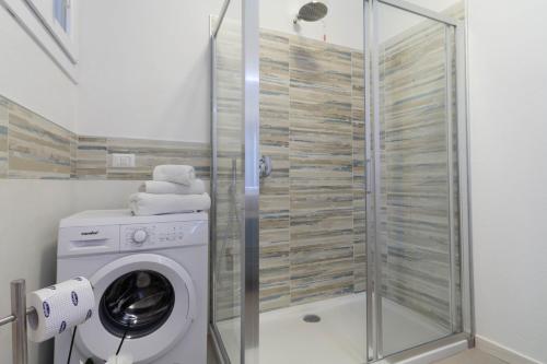 a washing machine in a bathroom with a shower at Le Casette Di Osvaldo in Lecco