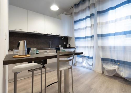 a kitchen with a table and chairs in a room at Le Casette Di Osvaldo in Lecco